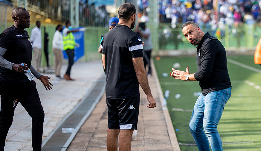 APR FC head coach Adil Muhammed Erradi chats with his assistant during the game. Olivier Mugwiza