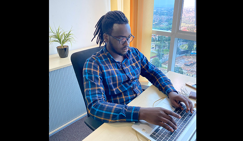 Didier Serge Dushime, a 23-year-old cloud engineer at work in his office. Photo/ Courtesy