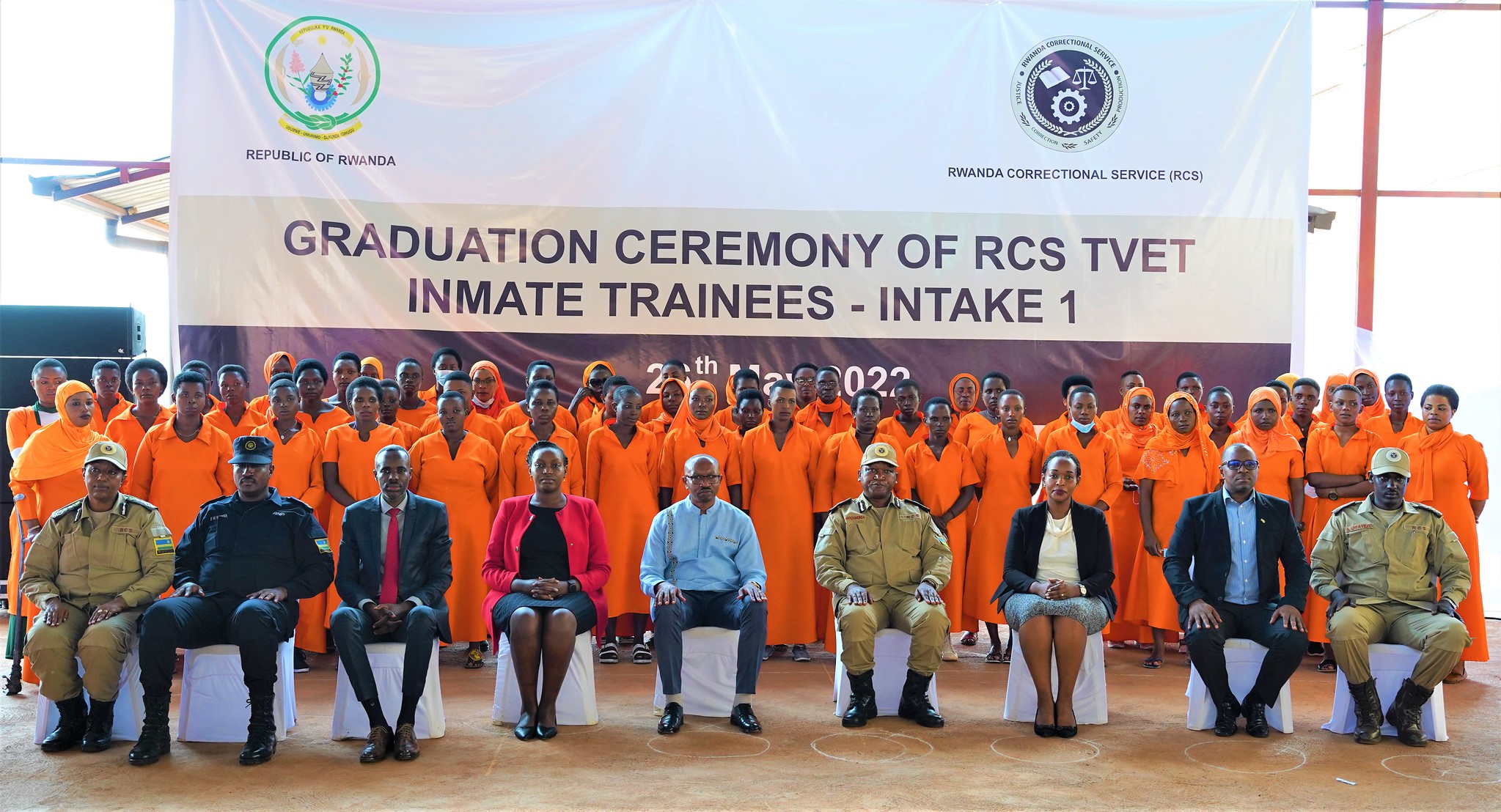 Officials pose for a group photo with graduates who completed their courses