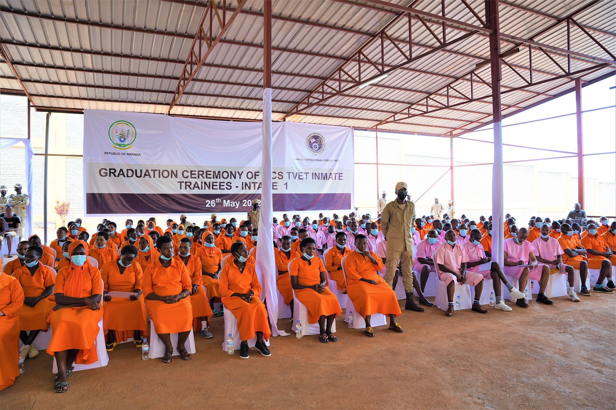 Officials pose for a group photo with graduates who completed their courses