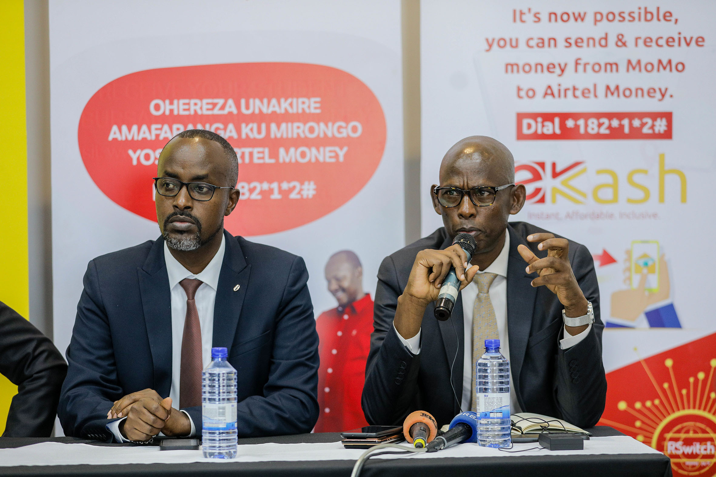 John Karamuka, the Director of Payment Systems at the Central Bank (right), graces the launch of eKash as Jean Claude Gaga, the Managing Director of Airtel Mobile Commerce Ltd, looks on in Kigali on Thursday, May 26./ Photos: Dan Nsengiyumva.