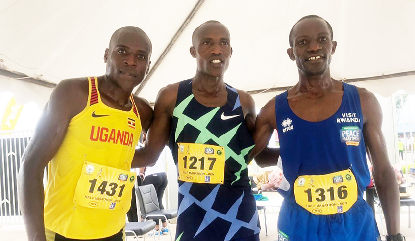 (L-R) Shadrack Kimining Korir, Gilbert Kamutwire and Rober Kajuga pose for a photo at Kigali International Peace Marathon on Sunday May 29. Net photo.