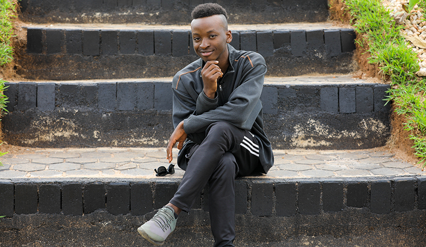 Awoke Ogbo sits on stairs constructed with bricks and pavers made from recycled plastic bottles. Photo: Courtesy.