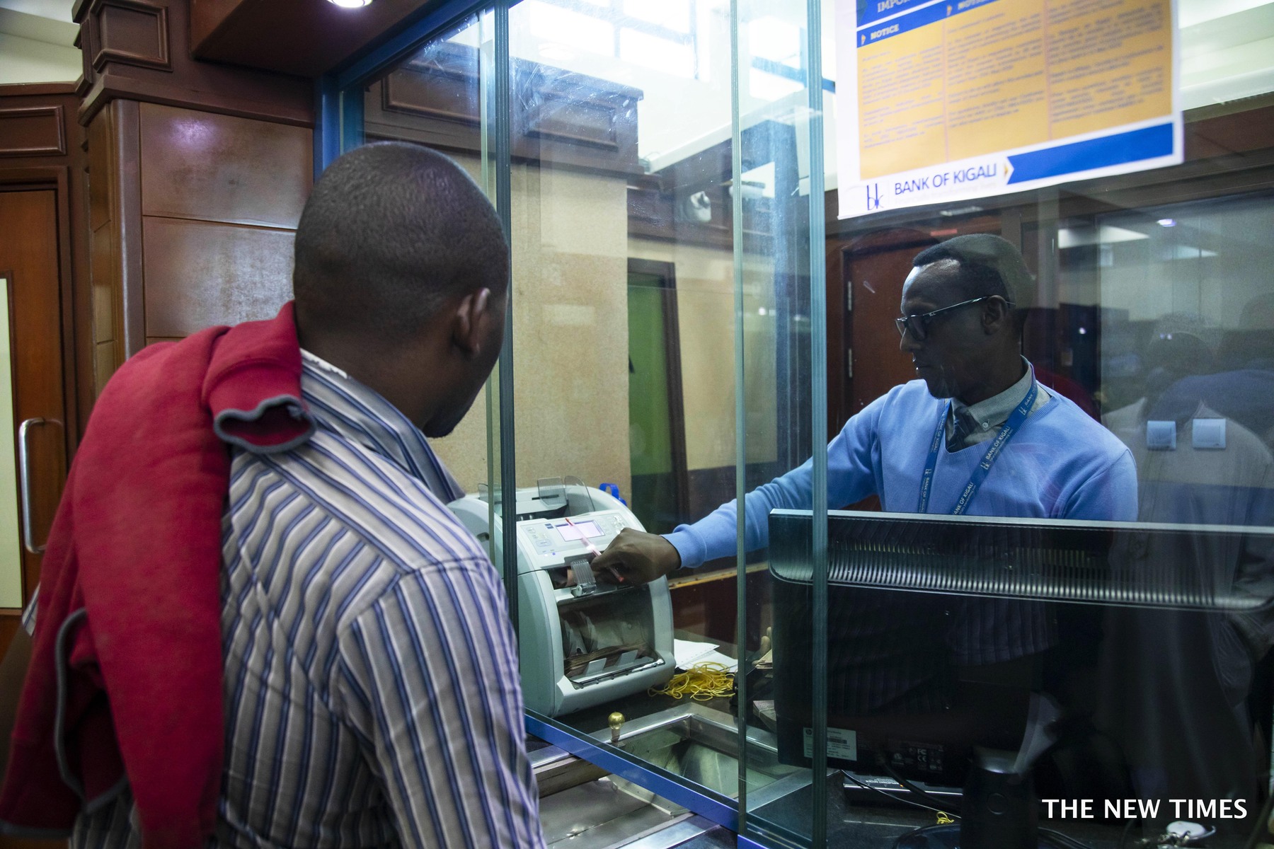 A teller serves a customer at Bank of Kigali headquarter in Kigali.BK Group Plc reported an after tax profit of Rwf15.6 billion in the first quarter of 2022, a 40 percent increase compared to the same period last year. 