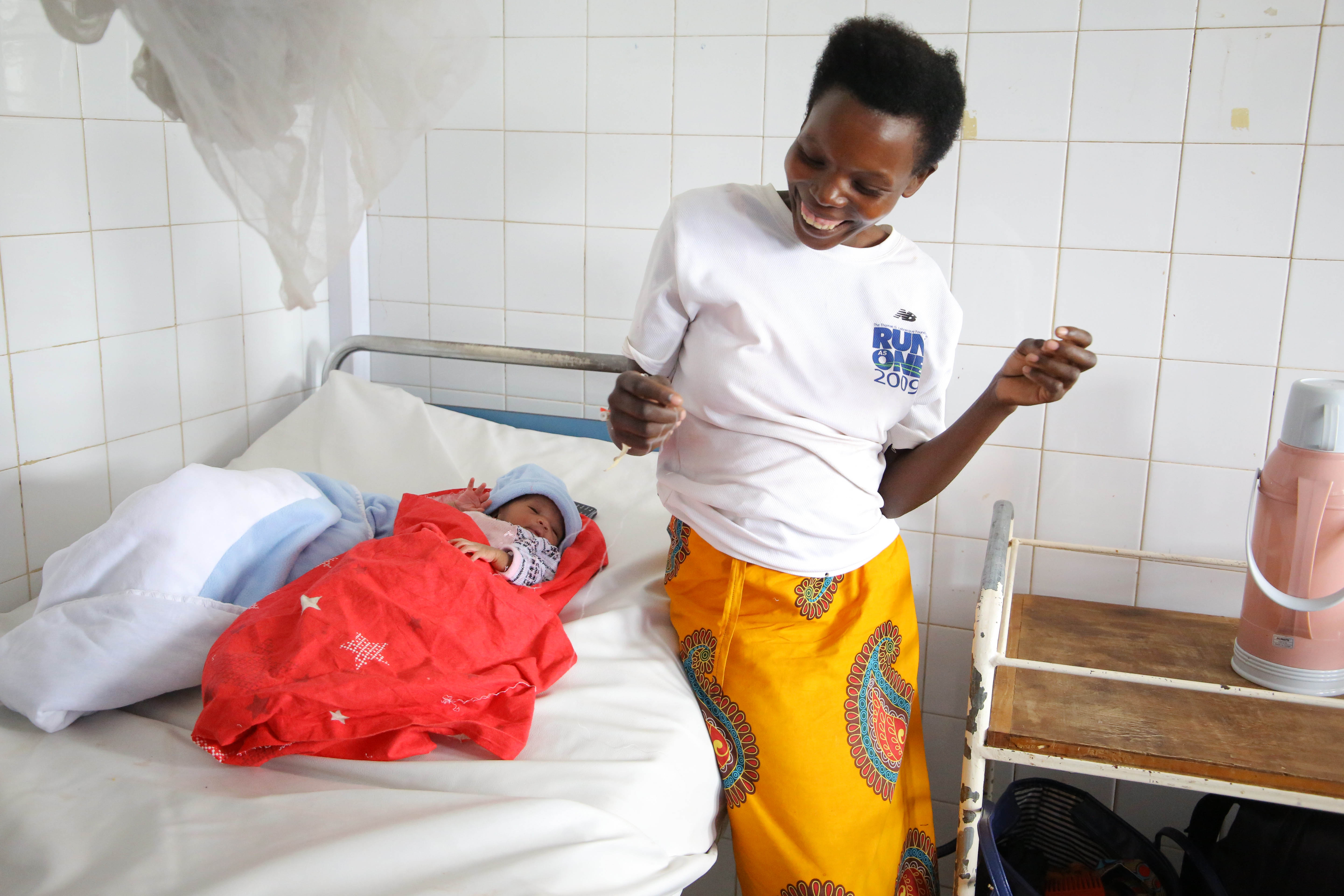 A woman looks so happy to welcome a baby boy after giving birth at Kacyiru Hospital in December 2020. Photo by Craish Bahizi
