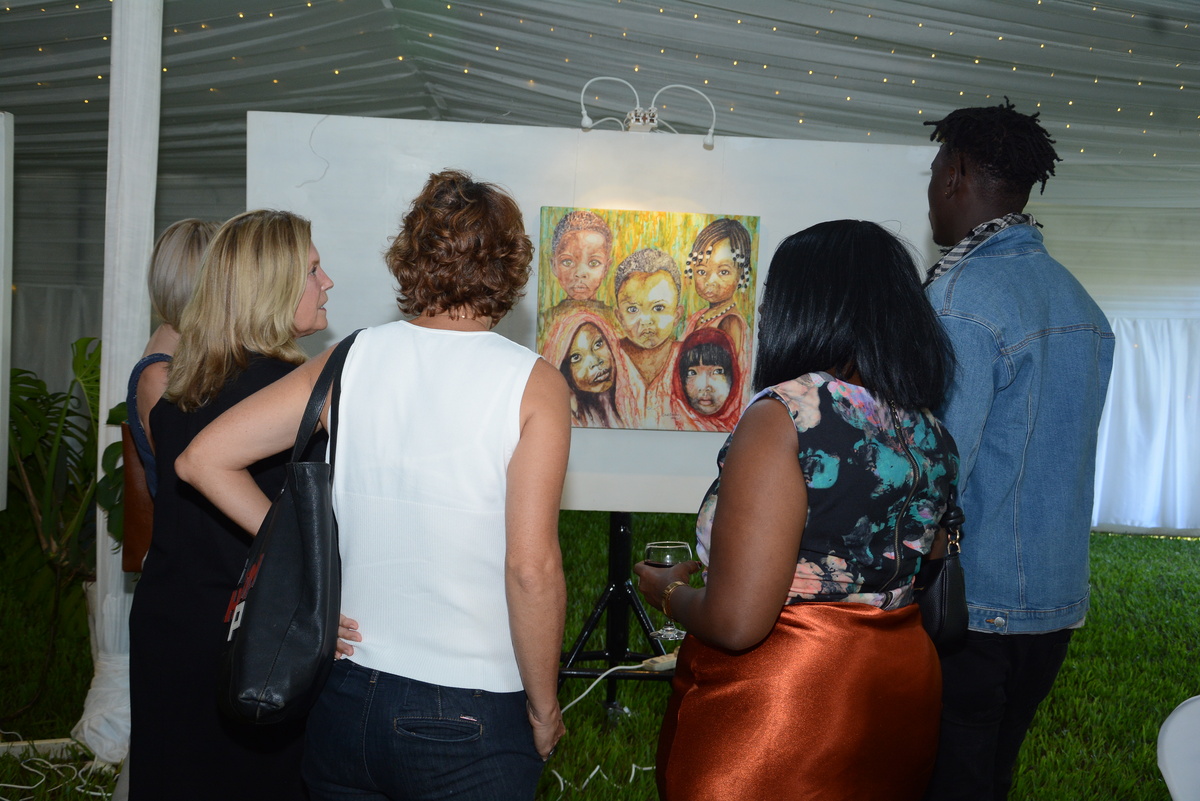 Some of the guests admiring one of the artworks by Cassady. 