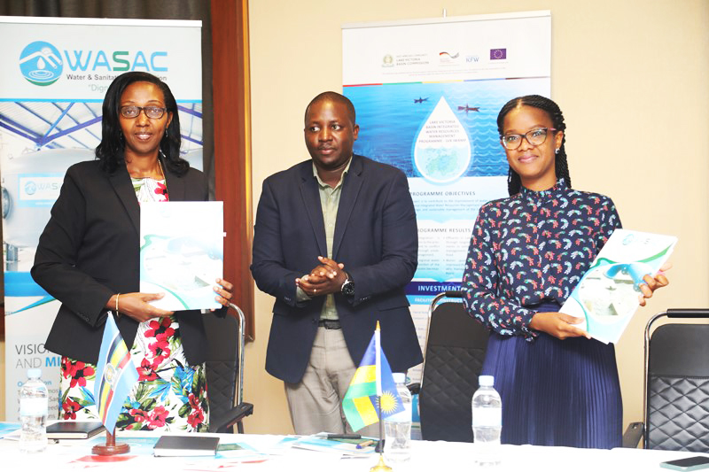Coletha Ruhamya, the Deputy Executive Secretary of  Lake Victoria Basin Commission  and Gisele Umuhumuza Acting Chief Executive Officer of WASAC exchange the documents during the signing ceremony in Kigali on June 9. Courtesy