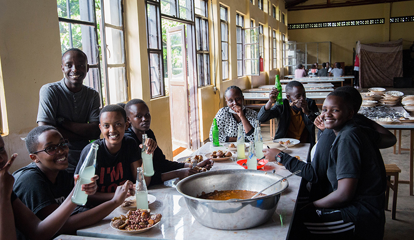 Students have lunch at Kagarama Secondary School. The use of gas for cooking in schools is being constrained by its increasing prices. Photo: Dan Nsengiyumva.