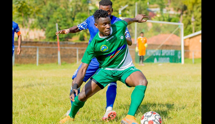 SC Kiyovu player tries to get past an Espoir defender in a league tie on Monday. Francis Haringingou2019s players failed to capitalize on APRu2019s slip up as they only managed a goalless draw. / Courtesy