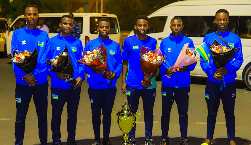 Moise Mugisha (3rd-L) and his teammates arrived in the country Monday night following a triumphant showing in Cameroon. Courtesy