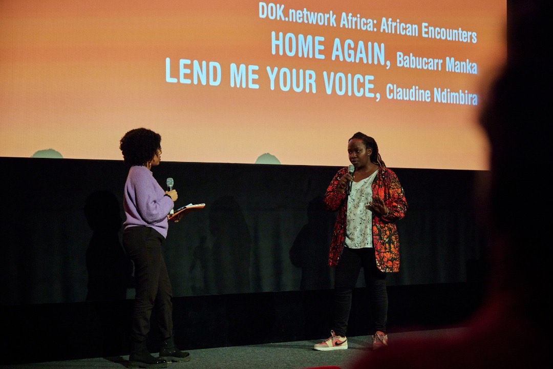  Rwandan filmmaker Claudine Ndimbira Shenge (R) presenting her documentary project u2018Lend Me Your Voiceu2019   at DOK.fest Mu00fcnchen 2022. The documentary will premier at Sheffield DocFest 2022. 