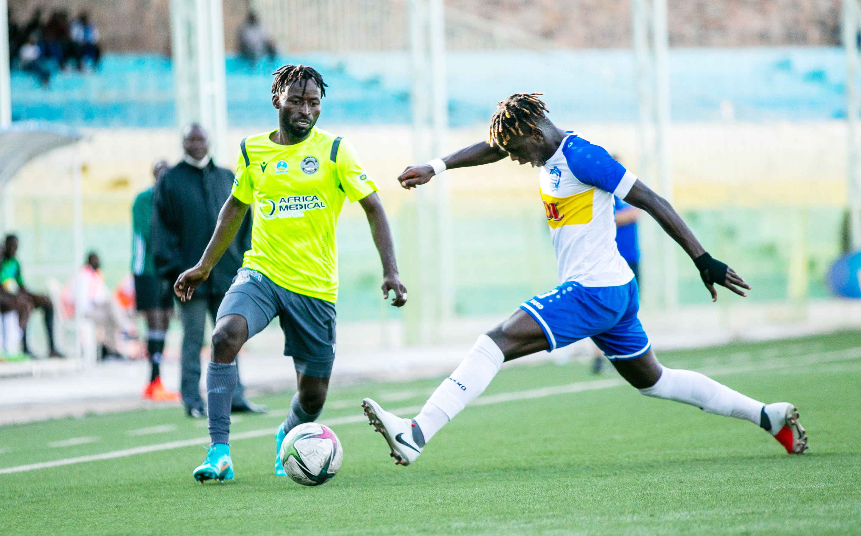 AS Kigali's striker Shaban Hussein Shabalala dribbles past Rayon Sports defender during the league match at Kigali Stadium on April 23, 2022. 