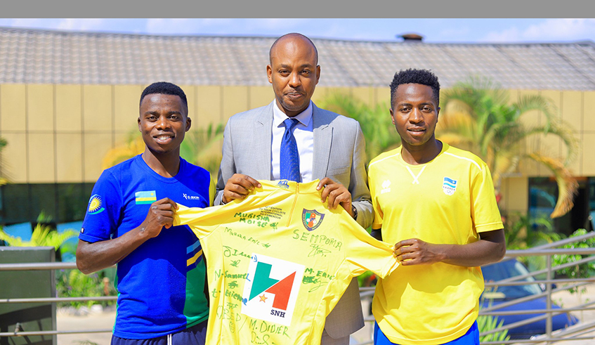 Abdallah Murenzi (M) poses for a photo with Moise Mugisha (L) and Didier Munyaneza who won the Tour du Cameroun on Sunday. Murenzi was re-elected to be Ferwacy President on June 11. Courtesy.