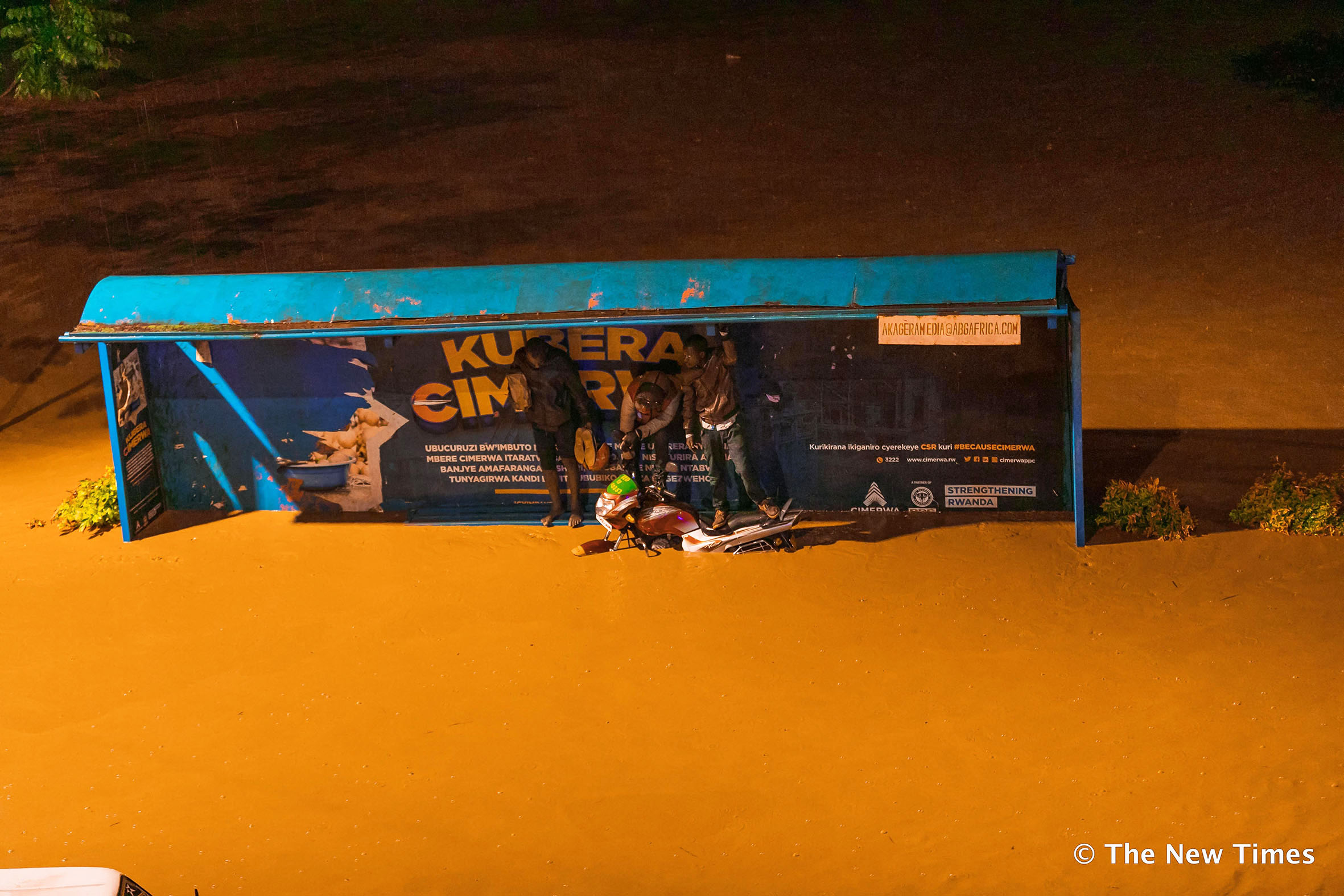 People stranded on a flooded street in Kigali in 2020. Climate justice experts have called for a strong financial mechanism for loss and damage compensation to African countries. Photo: File.