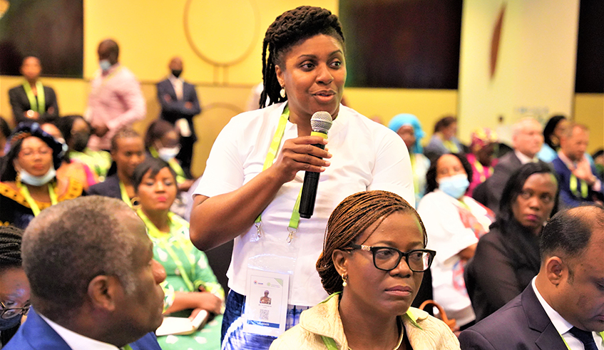 A delegate raises her comment on the theme dubbed 'Gender and climate change Interactions and opportunity for progress' during the Commonwealth Women Forum on June 21. / Craish Bahizi