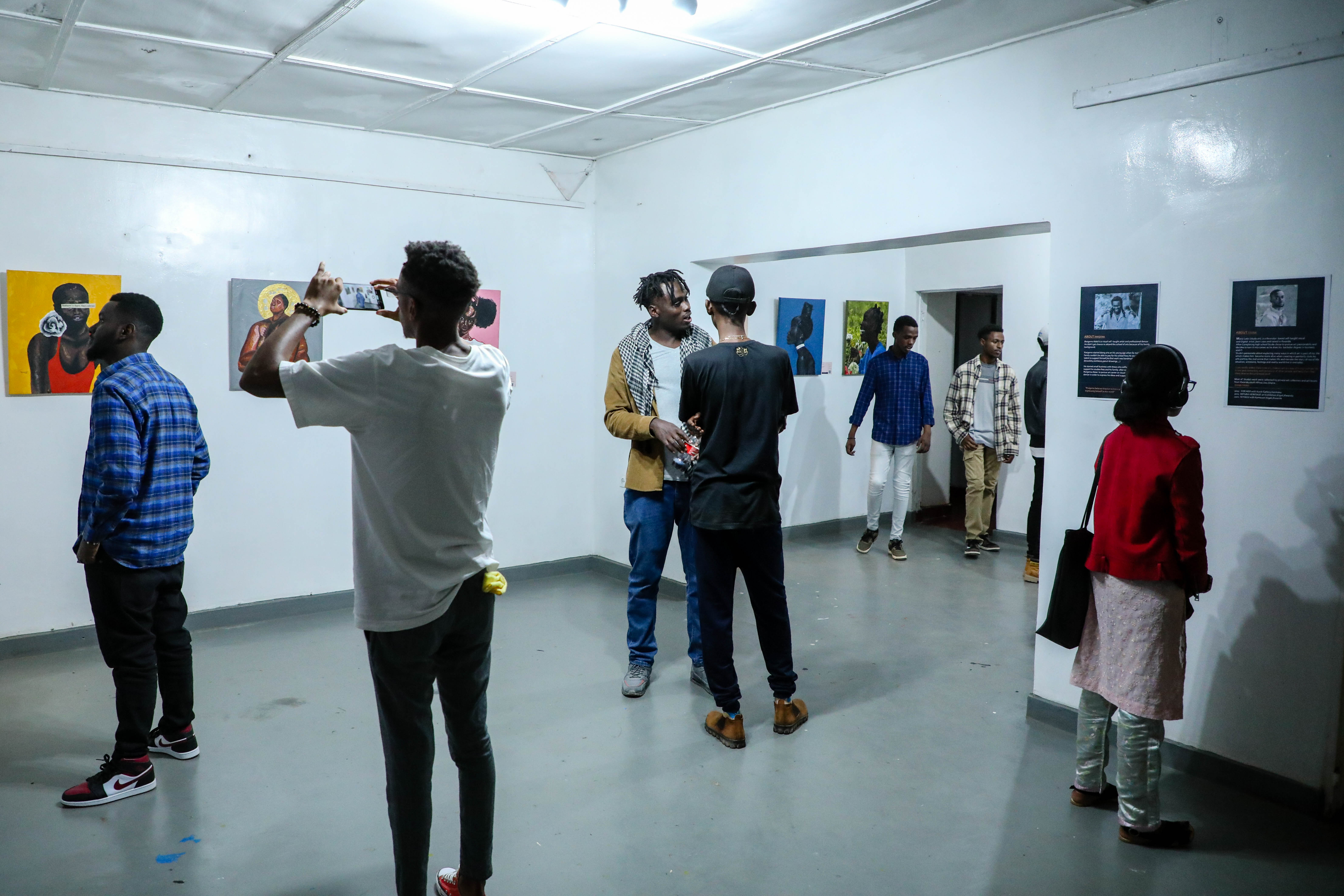 Guests admiring art pieces at the exhibition. / Photos: Dan Nsengiyumva