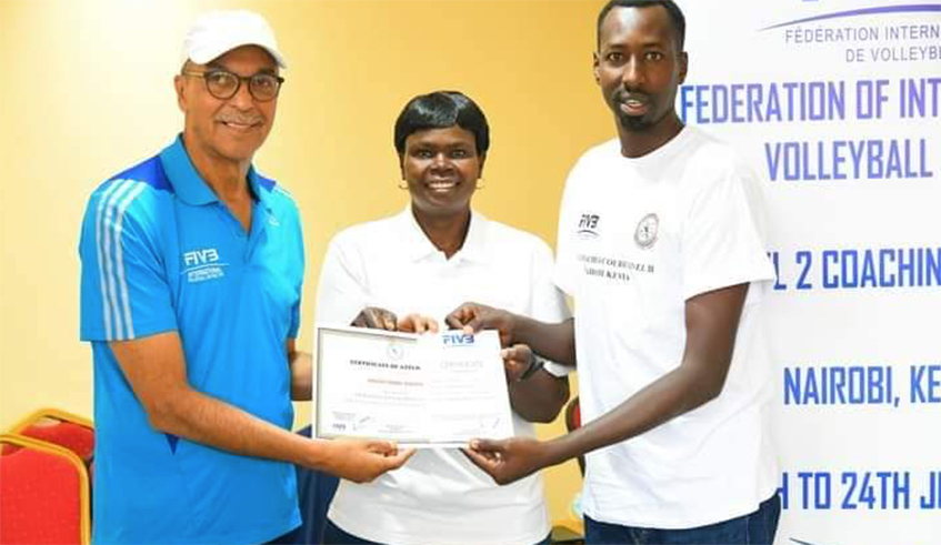 Kwizera Pierre b Marshal (right) gets a certificate from Fu00e9du00e9ration Internationale de Volleyball (FIVB) officials after the week-long training in Kenya. Photo: Courtesy.