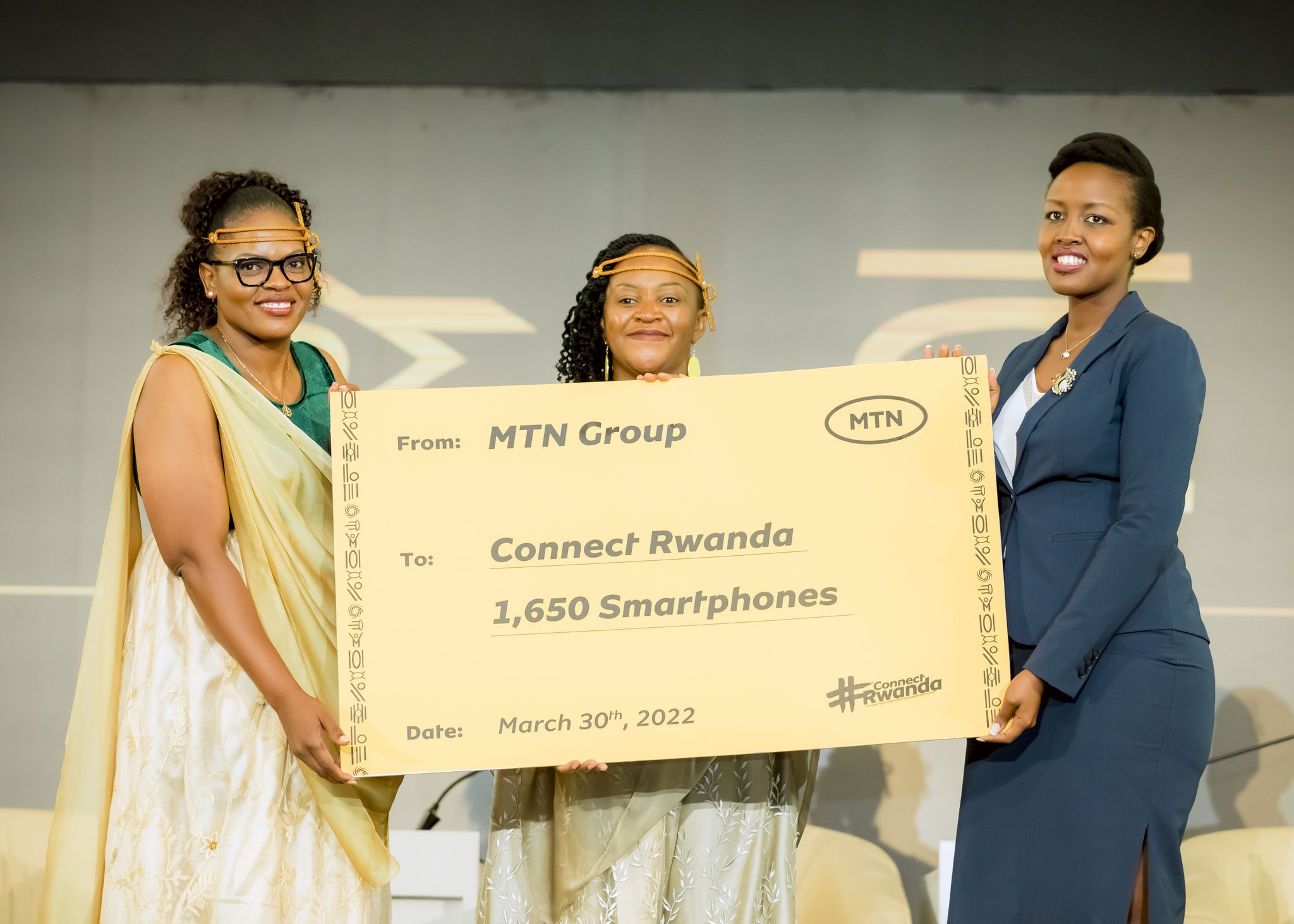 (L-R) Yolanda Cuba, the MTN Vice President in South and Eastern Africa; Mitwa Ng'ambi, the CEO of MTN Rwanda; hand over a cheque to Minister of ICT and Innovation Paula Ingabire on March 30. 