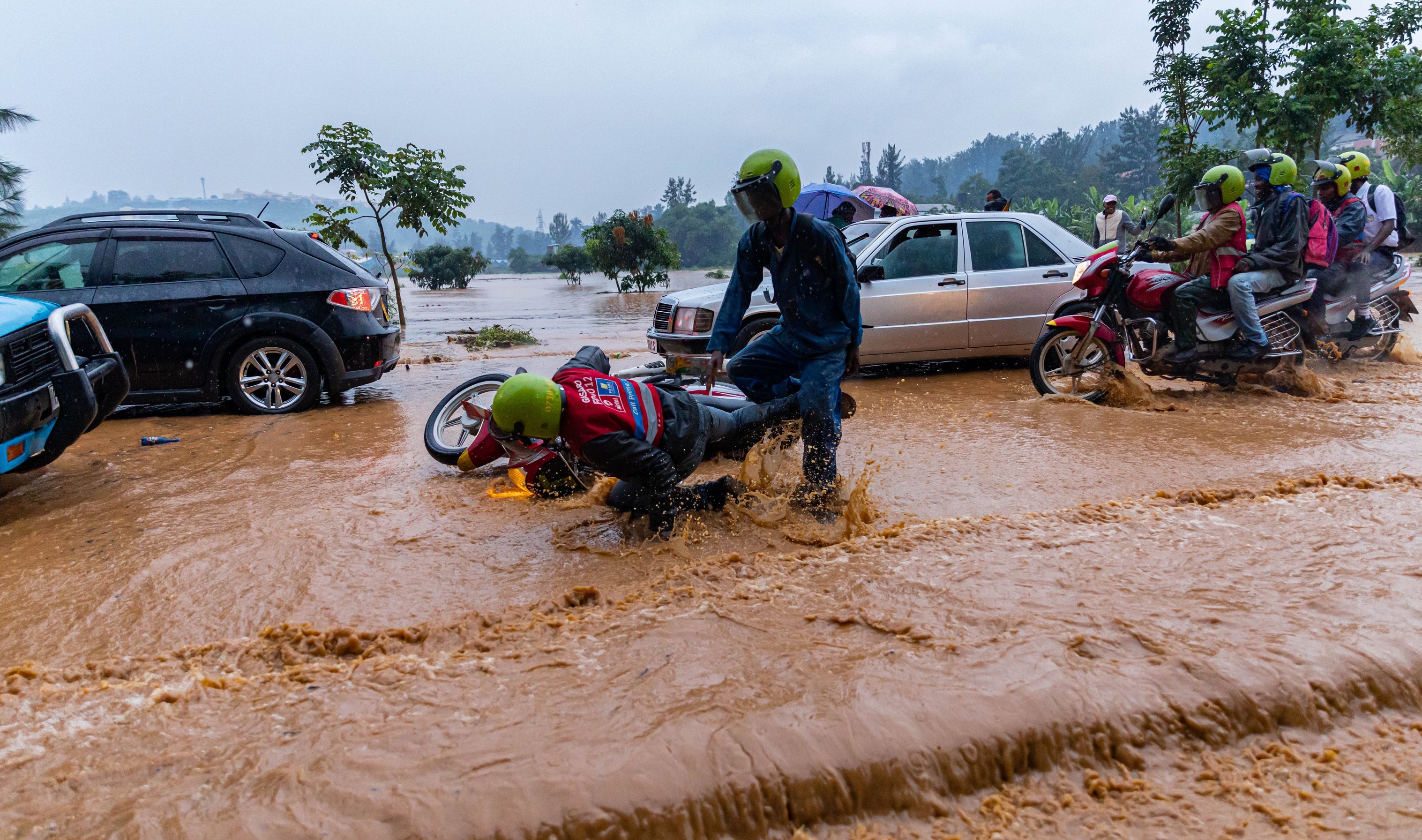 Road users wade through a flooded street in Kigali on on January 28, 2020. Kigali to get storm water master plan in two years. File