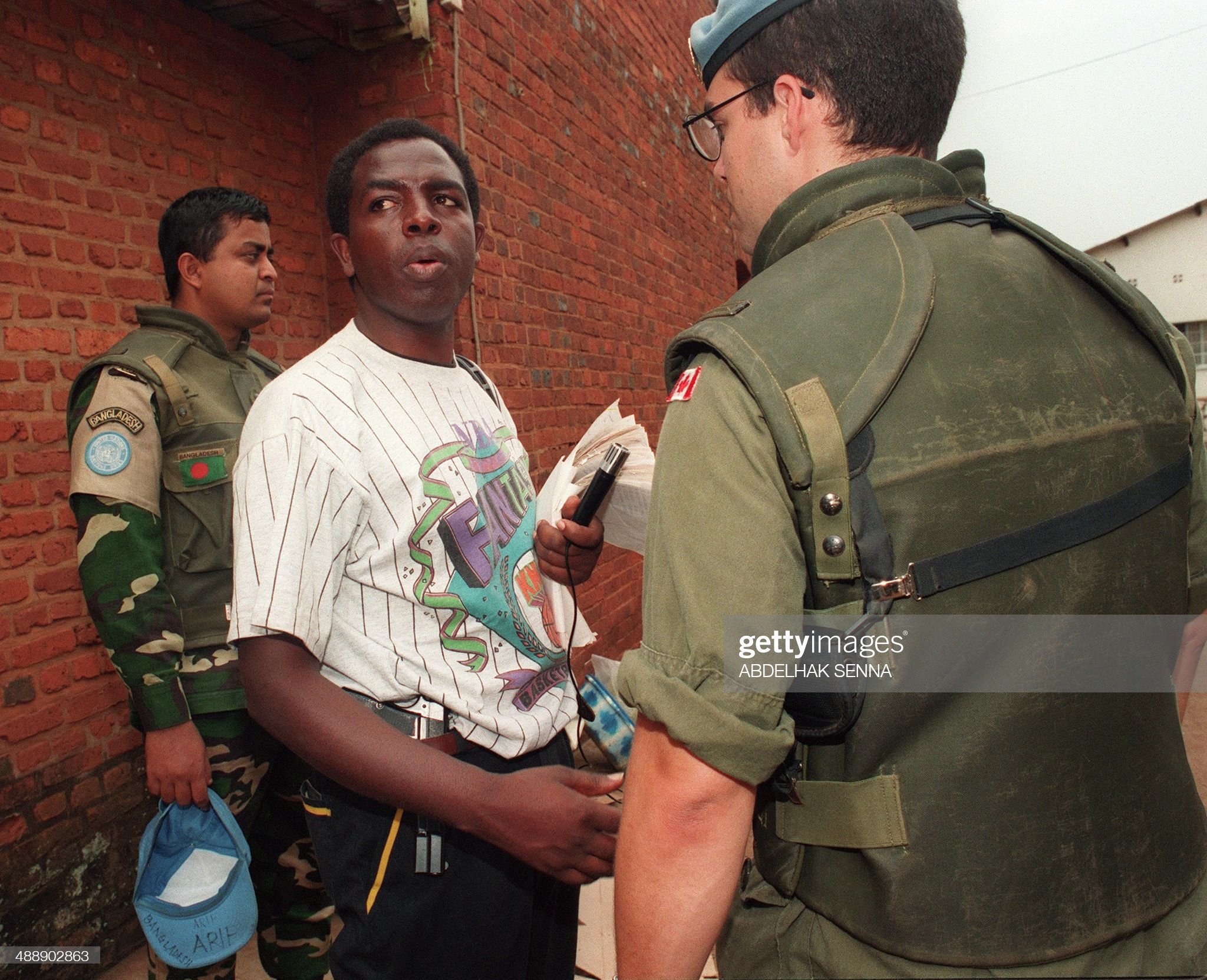 Munyeshyaka, (C) with a gun tucked under his belt. The priest openly moved with a gun throughout the Genocide against the Tutsi. (Photo courtesy of Getty Images)