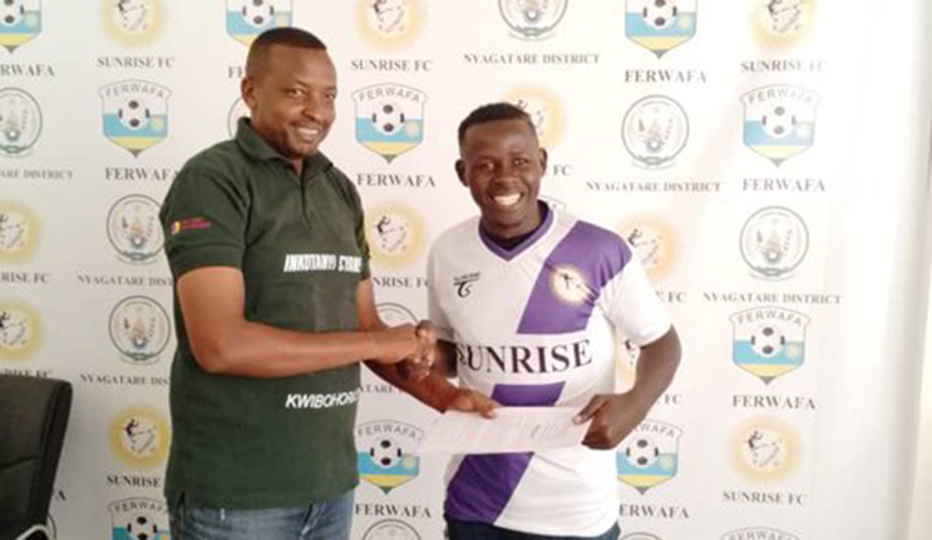 Brian Ssali (left) smiles after signing a two year deal to join Sunrise football club on Thursday. Photo: Courtesy.