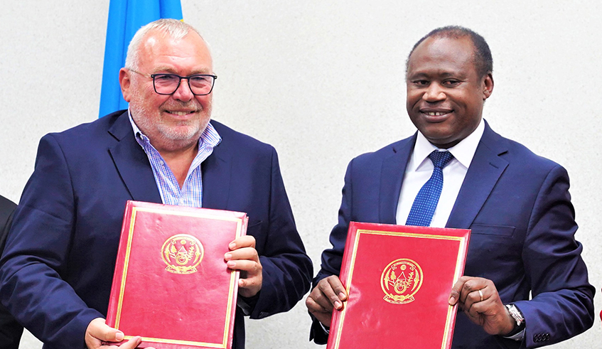 Former Austrian Chancellor, Alfred Gusenbauer and Minister of Finance and Economic Planning Uzziel Ndagijimana after signing the agreement in Kigali on July 18. / Photos by Craish Bahizi