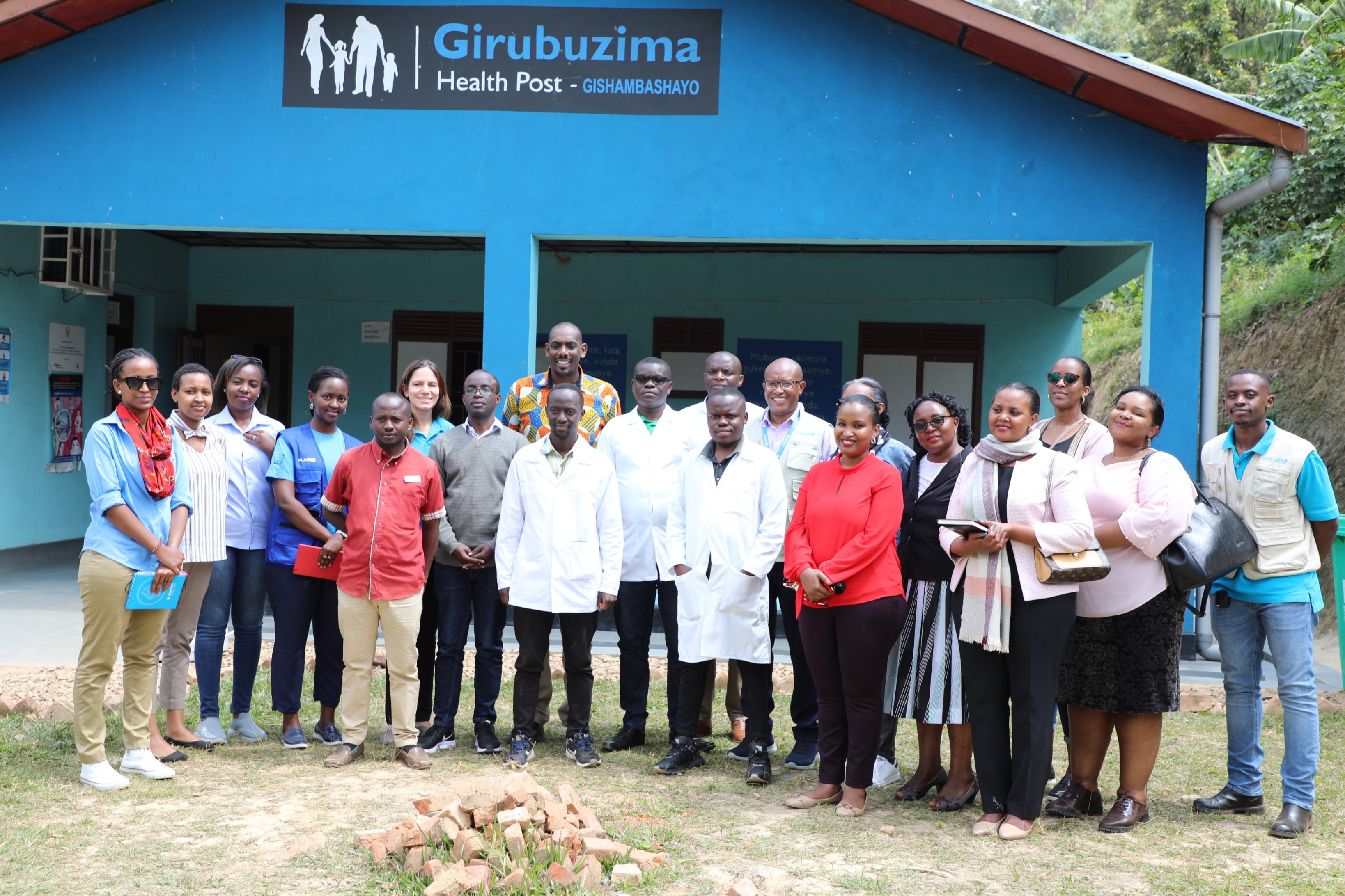 Officials and workers of the health post in a group photo . The health post was built through collaboration between UNICEF Rwanda, Society for Family Health (SFH), SC Johnson, and the Private Sector Federation.