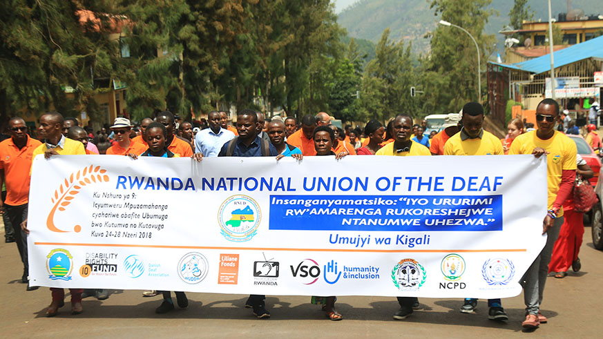 Members of Rwanda National Union of the Deaf march during a sensitization campaign for the integration of sign language in medical and health courses. 