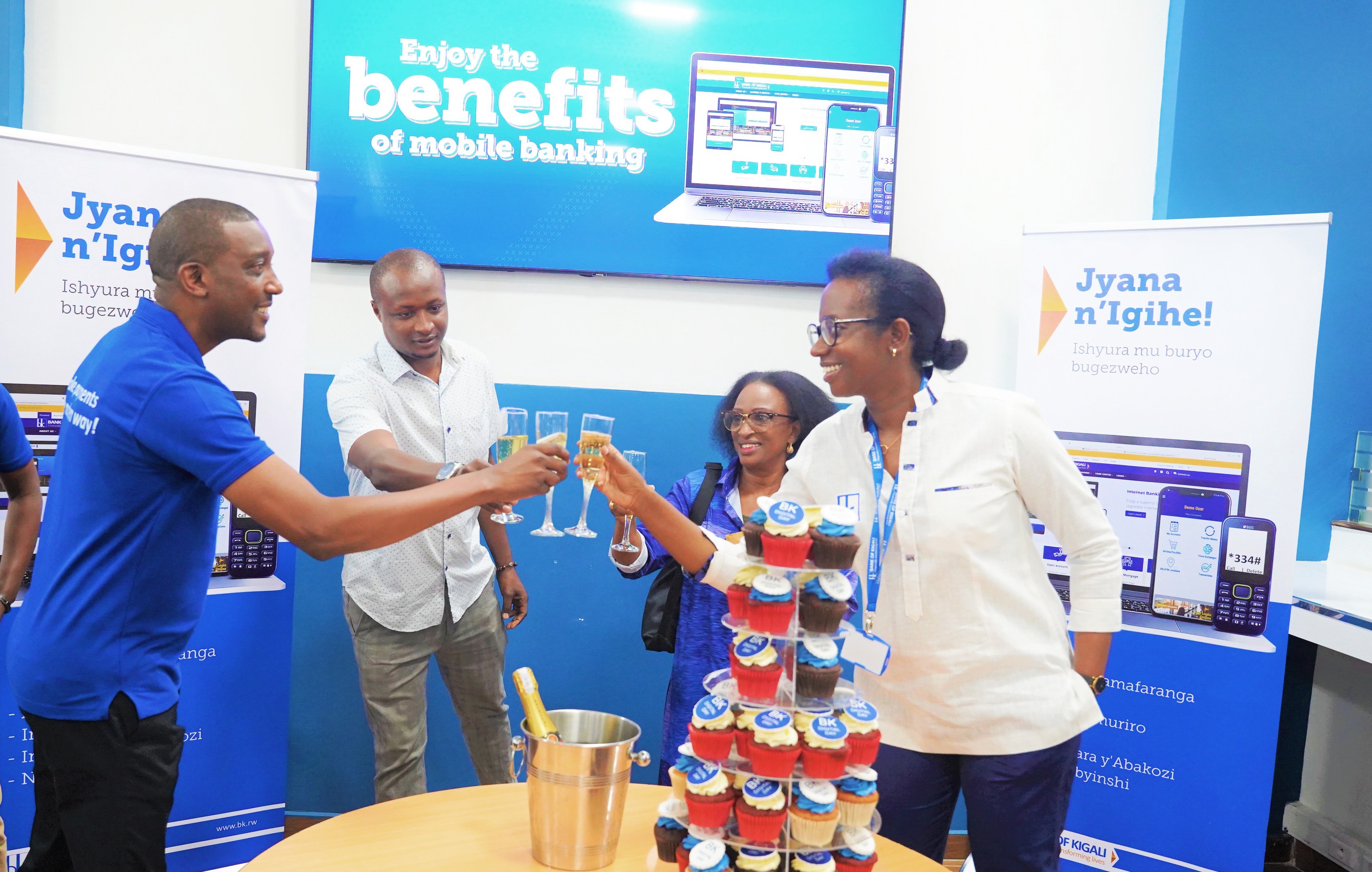 Bank of Kigali CEO Diane Karusisi toasts with customers during the launch of the Digital Day in Kigali on July 28. The day is part of the banku2019s efforts to bring more people onboard its various digital services. Craish BAHIZI