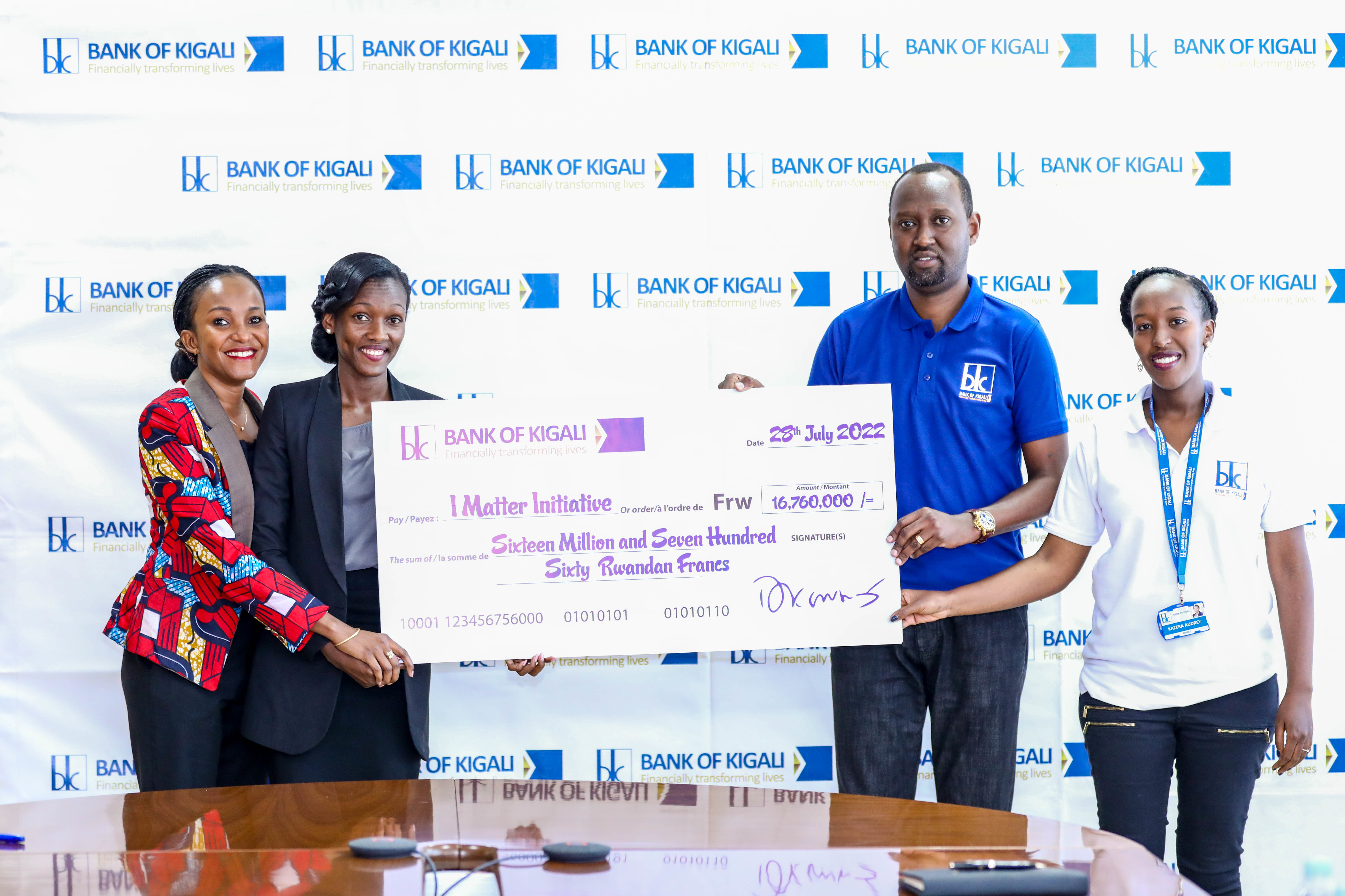 Emmanuel Nkusi Batanage, Head of Corporate Affairs at Bank of Kigali (2nd right), hands over the dummy cheque to Divine Ingabire, I Matter Initiative Executive Director (2nd left), during the launch of the partnership in Kigali on July 28. Photos: Dan Nsengiyumva.