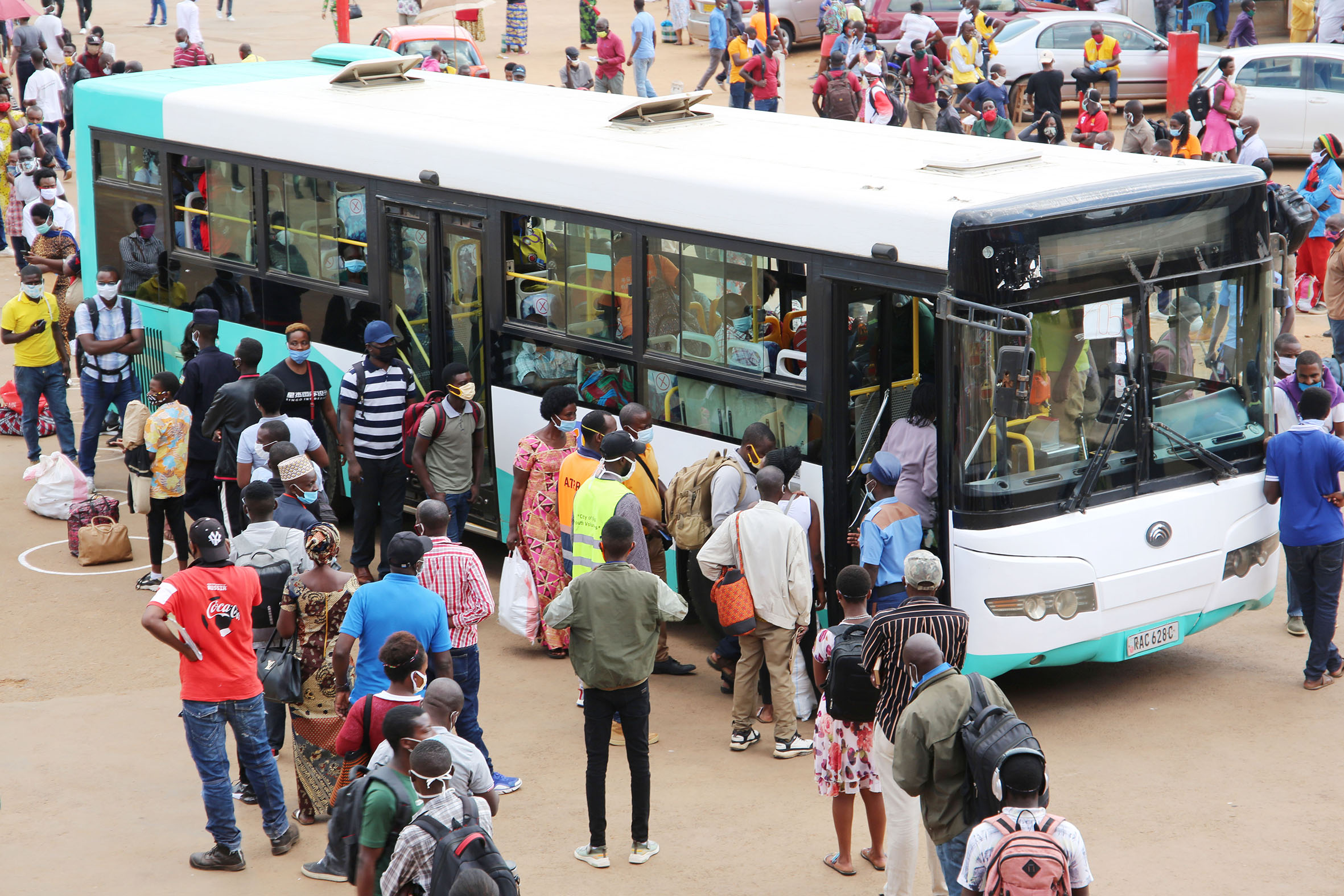 Passengers  queue to board  a bus at Nyabu- gogo taxi park.  Commuters say the only way to fix the public transport sector is to avail as many buses as possible. Photo: Craish Bahizi.