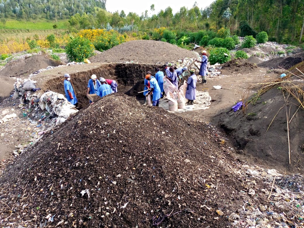 Workers pack fertiliser at a compost site in Musanze District. Photo: Courtesy.