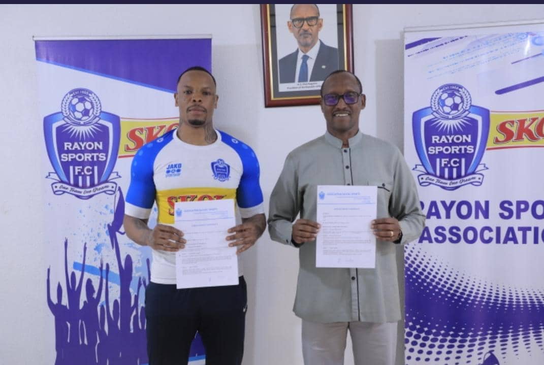 Abdul Rwatubyaye displays his contract after signing a two-year-deal at Rayon Sports on Tuesday. On his right is Rayon Sports Chairman, Jean FidAu0303u00a8le Uwayezu. Courtesy